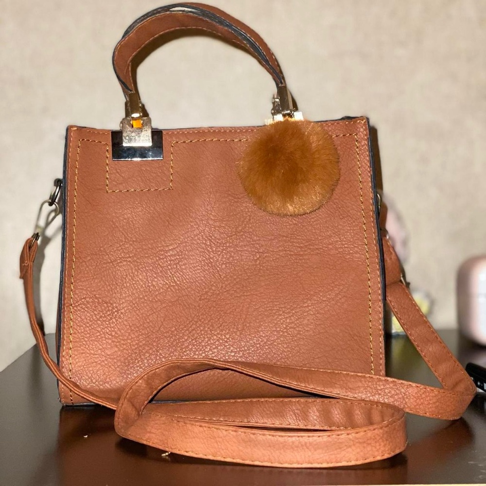 Brown lightweight handbag with attachable strap.